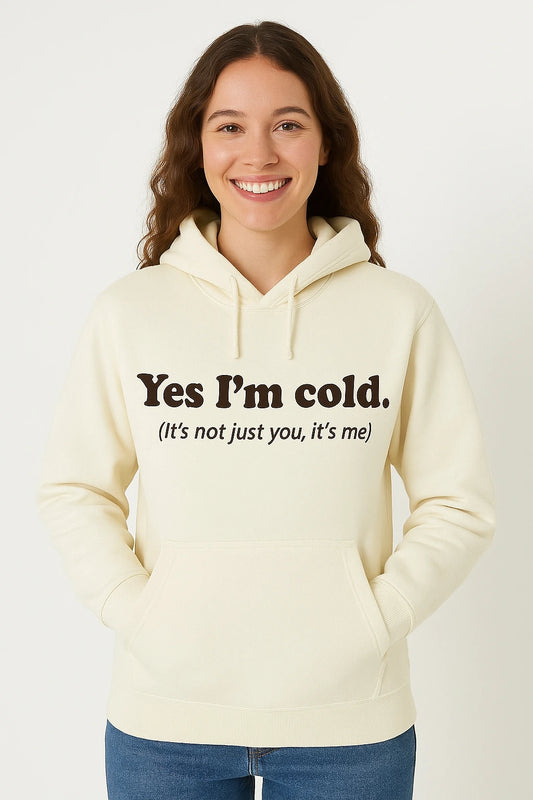 Person wearing a cream hoodie with text, standing against a white background